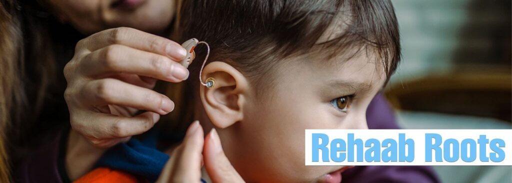 A close-up of a young child being fitted with a hearing aid by an adult, highlighting early intervention and support with hearing aids in Hyderabad.