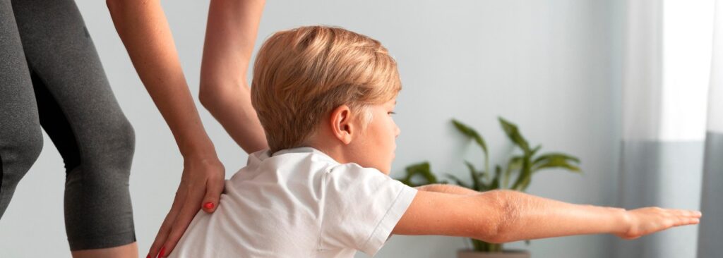 A physiotherapist helping a child with therapy exercises